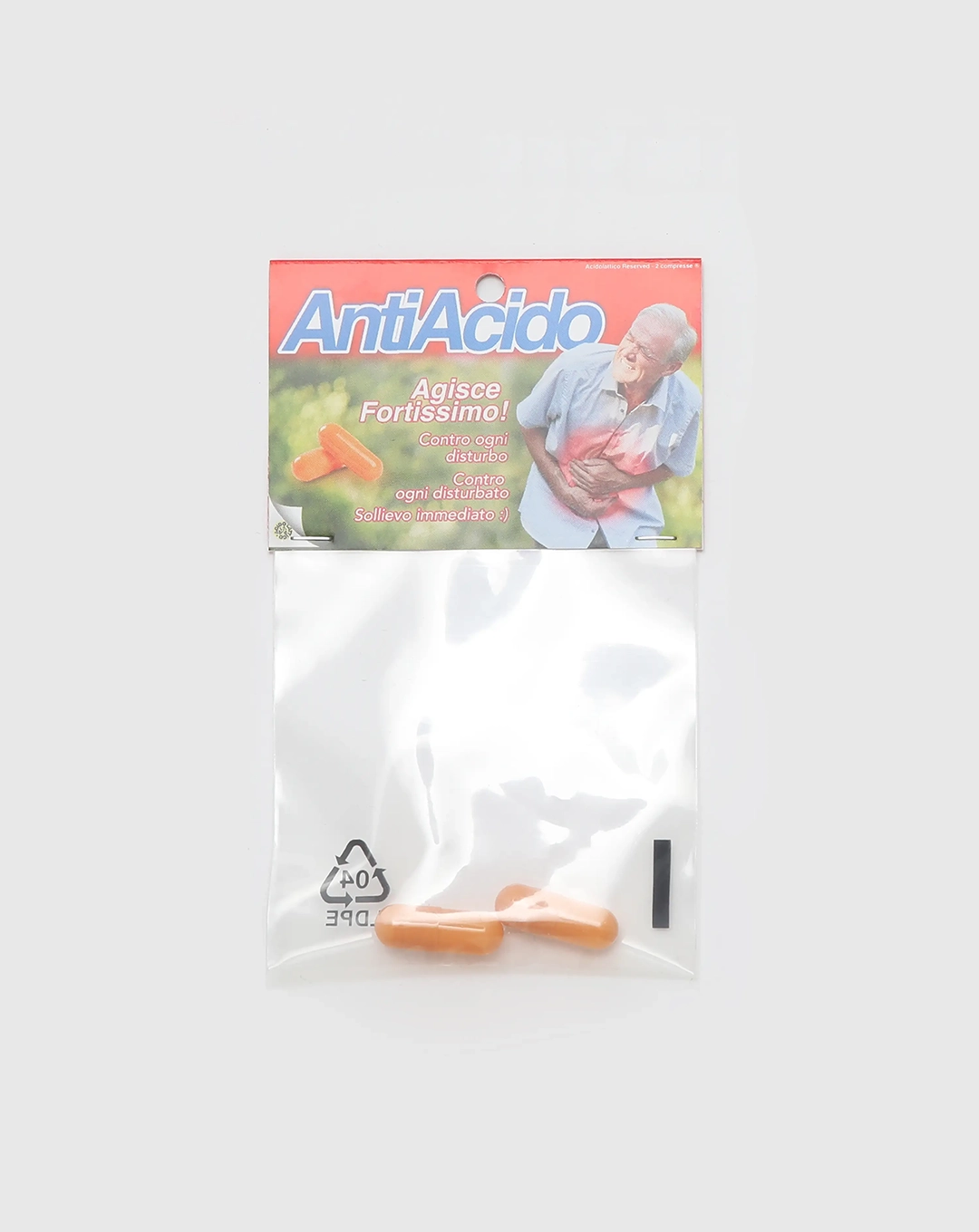 Confezione di Antiacido Pills con un design ironico e la scritta 'Agisce Fortissimo!' contro disturbi e disturbi d'animo. Include due pillole arancioni.