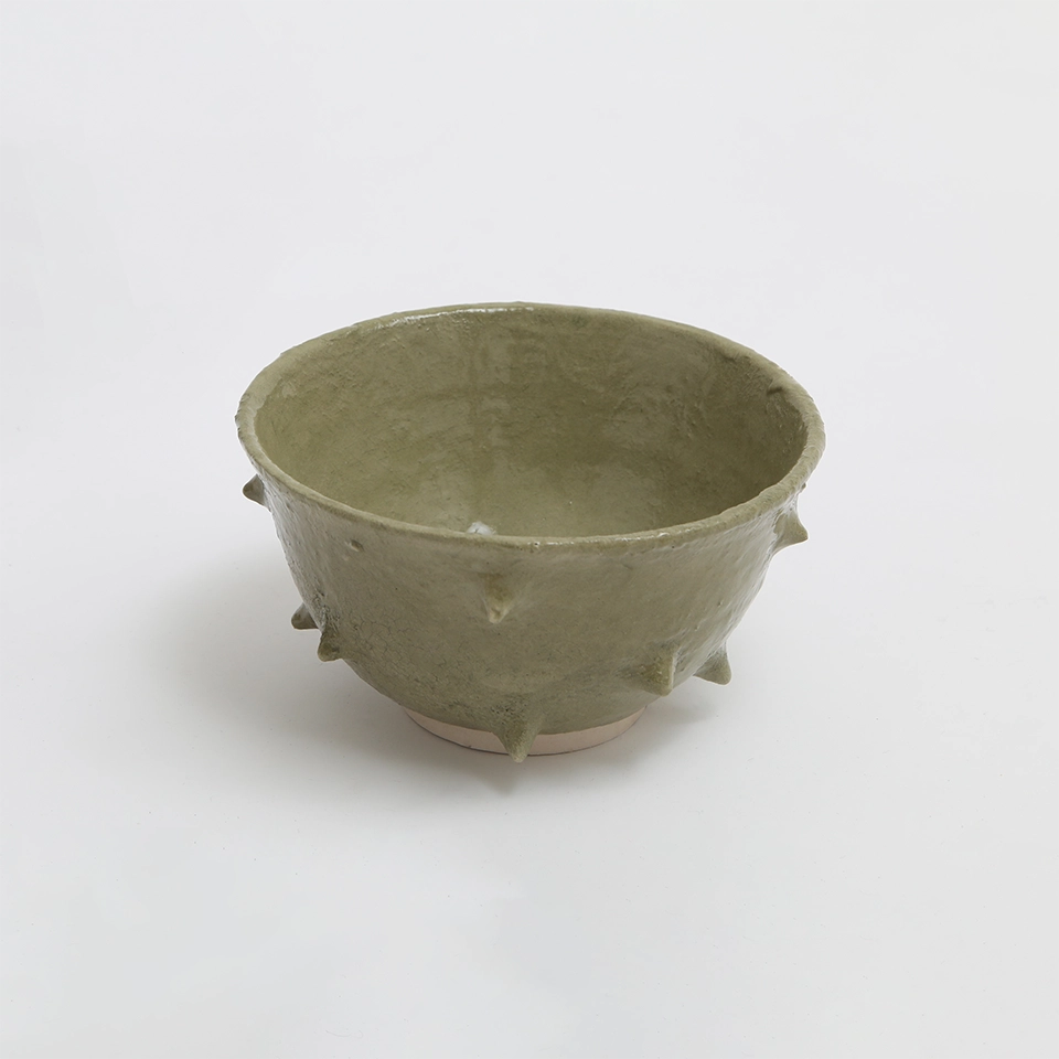 Ramen Bowl verde progettata da Acidolattico Magazine, con un design artigianale e rilievi sulla superficie.