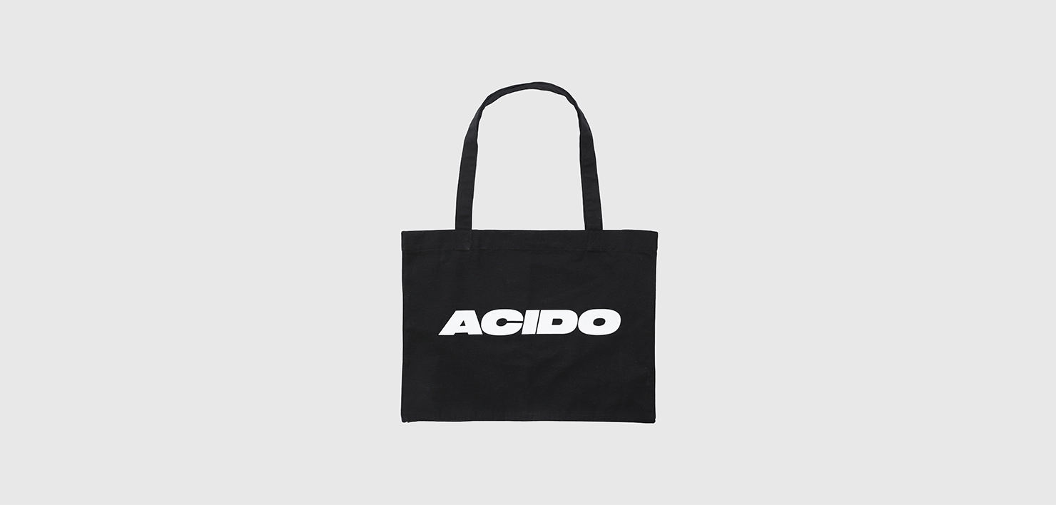 Totebag nera in tessuto con il logo 'ACIDO' stampato in bianco sulla parte frontale.