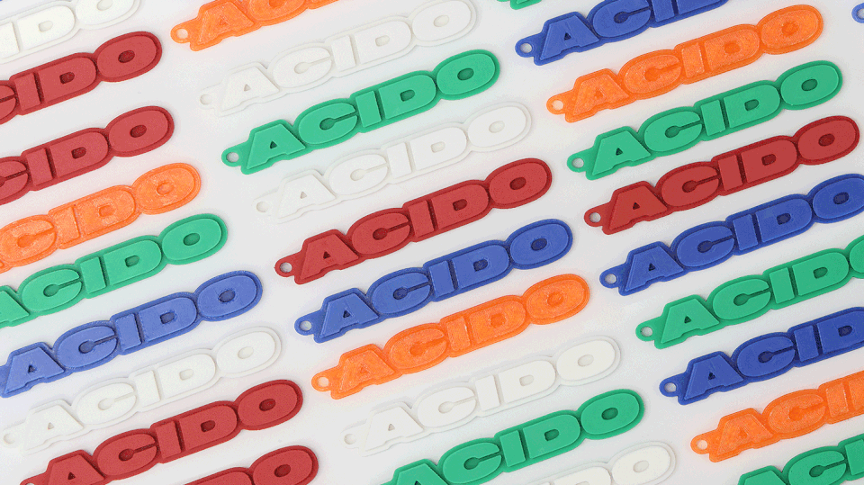 GIF che mostra diversi portachiavi 'ACIDO' colorati e dettagli del prodotto.