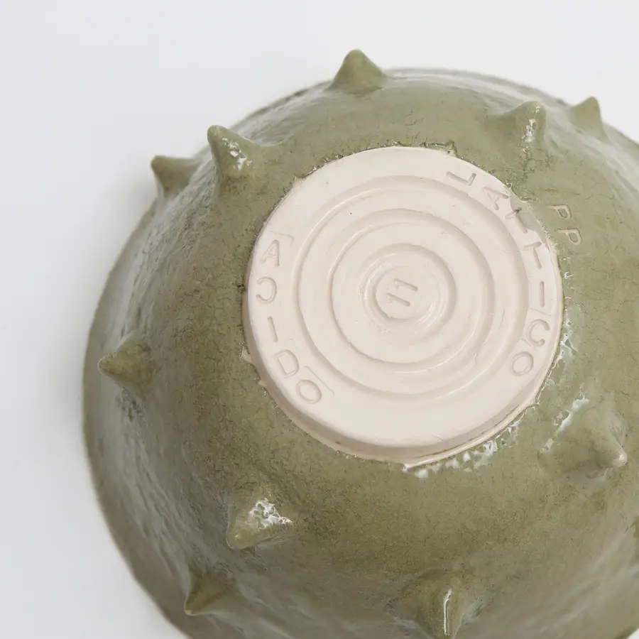 Dettaglio della base della Ramen Bowl verde, con texture in rilievo e logo 'ACIDO' inciso.